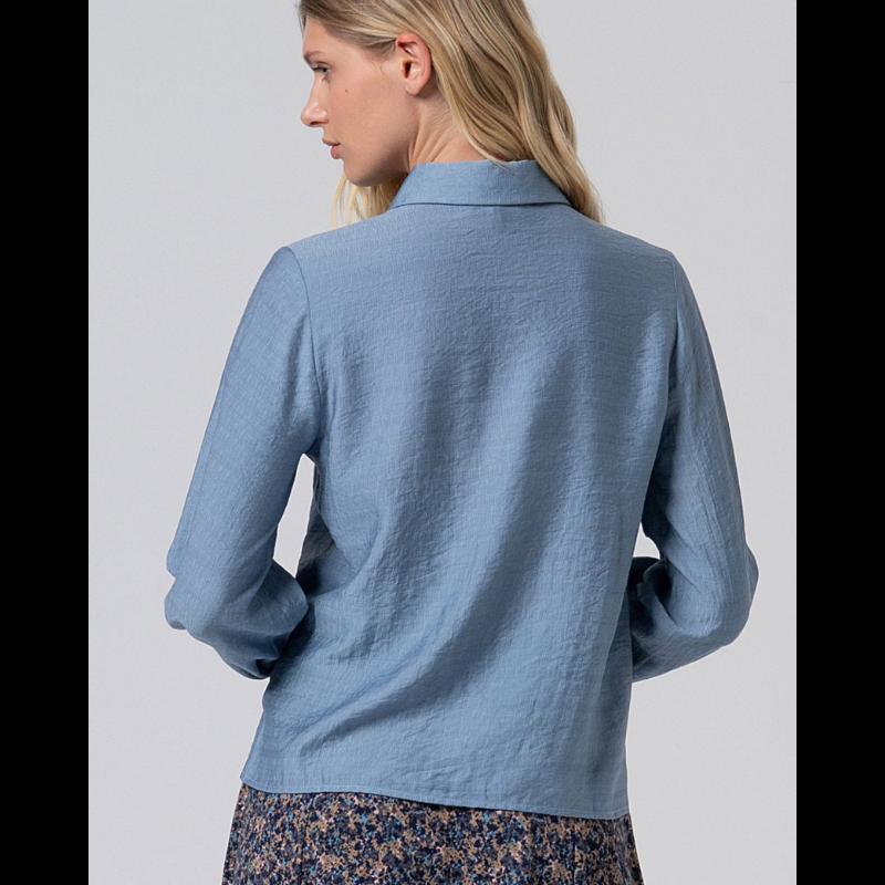 Camisa de manga comprida, em cinzento azulado, com folhos.
Composição: 80%Viscose + 20%Poliamida