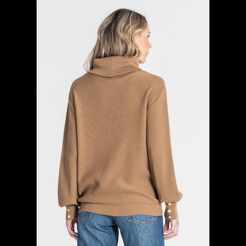 Camisola, em camel, com bordado RG na frente e de gola alta caída. Camisola de manga comprida com detalhe de três botões nos punhos.