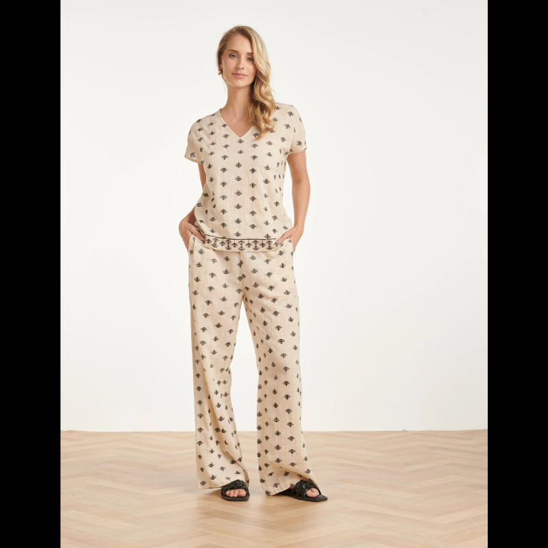 Blusa bege em algodão com manga curta e decote em V elegante. Destaca-se pelo bordado gráfico asteca em preto e castanho, que adiciona carácter e sofisticação ao design. Peça versátil, perfeita para criar looks casuais ou semi-formais. Confortável e fácil de combinar com calças ou saias.