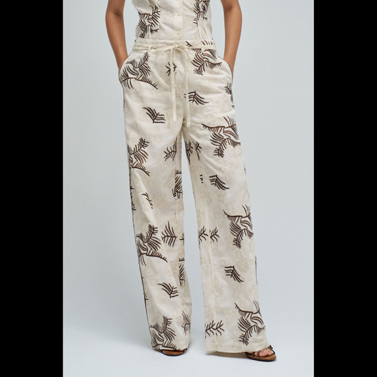 Calças em tom cru e castanho com detalhes de bordados e missangas que trazem personalidade ao visual. Corte regular confortável, com forro em calção, ideal para o dia a dia, com presilhas na cintura e cordão ajustável para um encaixe perfeito. Dois bolsos funcionais completam o design prático e versátil desta peça essencial do guarda-roupa.