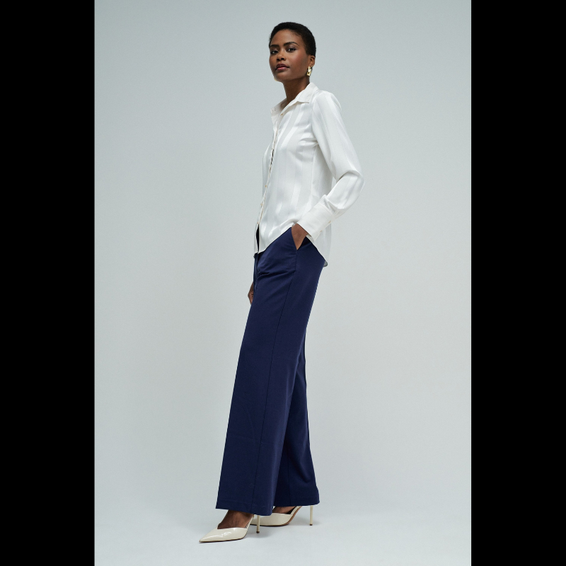 Camisa acetinada de corte regular com riscas em Lurex que adiciona um toque de sofisticação ao seu guarda-roupa. Confecionada em branco puro, apresenta mangas compridas e decote de colarinho clássico. O fecho frontal com botões e os punhos abotoados garantem um ajuste preciso e confortável. Ideal para ocasiões que exigem elegância discreta com um detalhe luminoso.