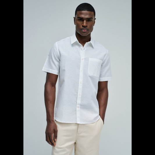 Camisa de manga curta em linho, perfeita para os dias quentes. Cor branco puro com fit regular que se adapta confortavelmente ao corpo. Apresenta decote clássico com colarinho, abertura frontal com botões funcionais e bolso prático no peito. O linho garante respirabilidade e um toque natural, ideal para criar looks casual e sofisticados. Uma peça versátil que combina com calças, shorts ou saias para qualquer ocasião.