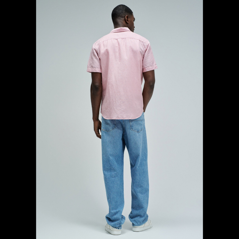 Camisa de manga curta em linho, perfeita para os dias quentes. Cor rosa com fit regular que se adapta confortavelmente ao corpo. Apresenta decote clássico com colarinho, abertura frontal com botões funcionais e bolso prático no peito. O linho garante respirabilidade e um toque natural, ideal para criar looks casual e sofisticados. Uma peça versátil que combina com calças, shorts ou saias para qualquer ocasião.