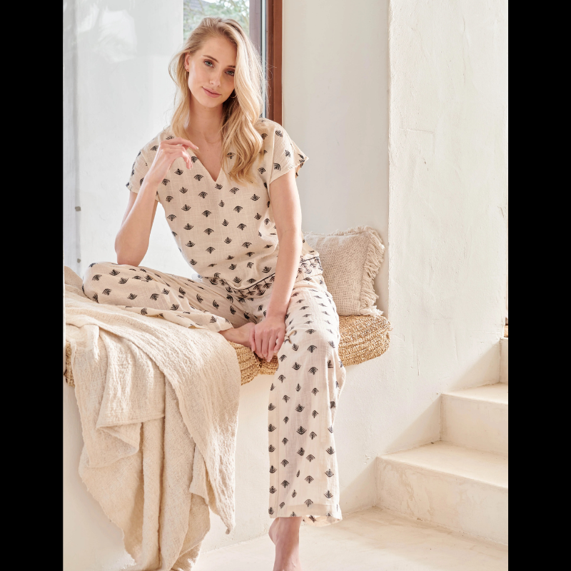 Calças beges Wide Leg com estampado Azteca em preto e castanho. Calças com bolsos nas laterais e cintura com elástico na parte de trás.