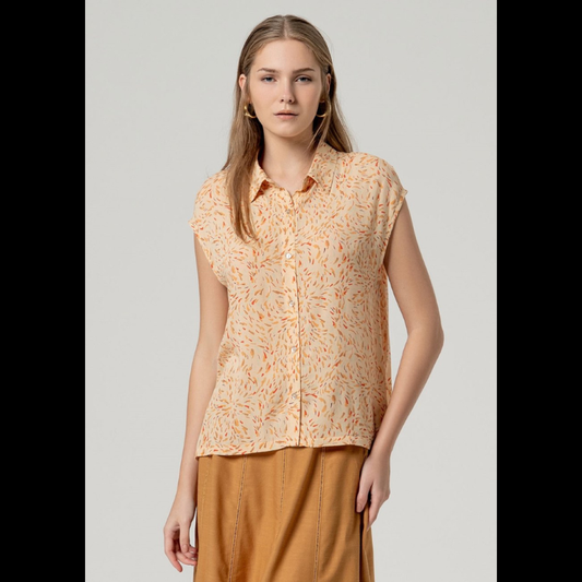 Camisa sem mangas SURKANA em tom areia com padrão vibrante em laranja, vermelho e castanho. Fechamento frontal com botões para um ajuste personalizado. Corte solto e leve, perfeito para dias quentes, com prega-macho na parte de trás que proporciona conforto e movimento. Uma peça versátil para criar looks descontraídos e elegantes.