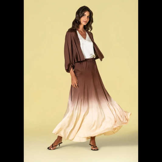 Casaco curto em acetinado castanho com um toque de elegância descontraída. Design versátil que permite usar solto para um visual relaxado ou atar em nó para um acabamento mais ajustado e sofisticado. As mangas em balão adicionam movimento e feminilidade ao corte, criando uma silhueta moderna e confortável. Perfeito para transições de estação e looks do dia a dia com estilo.