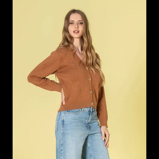 Casaco em tom caramelo com relevo animal print que traz profundidade e dinamismo ao seu estilo. O decote V proporciona uma linha elegante e alongadora, complementado por botões dourados com assinatura de marca que elevam o design. Peça de grande versatilidade, perfeita para composições sofisticadas tanto em contextos casuais como em momentos que exigem maior formalidade.