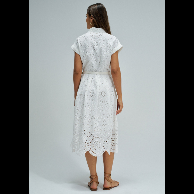 Vestido camiseiro em bordado inglês branco, perfeito para um look elegante e sofisticado. Apresenta manga curta, abertura frontal com botões e comprimento midi que favorece qualquer silhueta. Equipado com cinto removível para ajustar o caimento conforme deseja, bolsos funcionais e forro interior para maior conforto. Uma peça versátil que combina com facilidade no seu guarda-roupa do dia a dia.